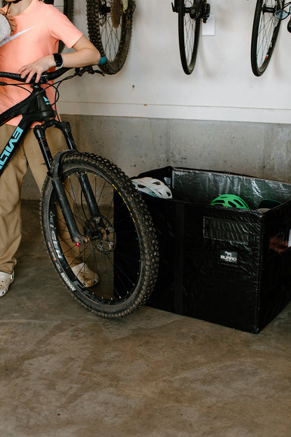 Burro Bag full of helmets and other mountain biking necessities