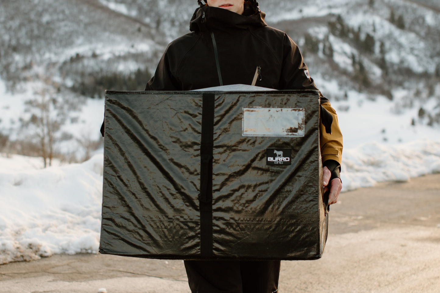 Man carrying the Burro Bag filled with winter essentials